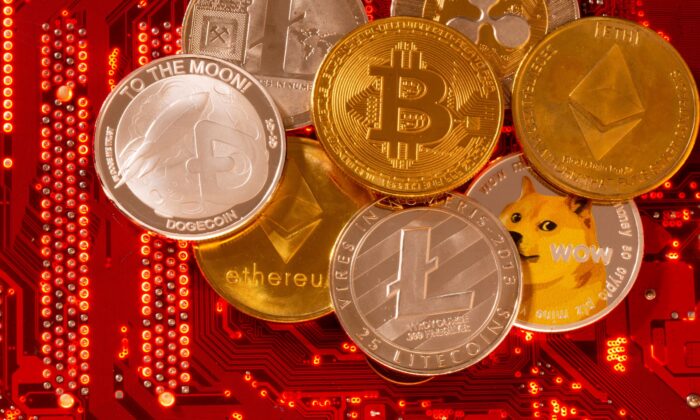 Representations of cryptocurrencies Bitcoin, Ethereum, DogeCoin, Ripple, Litecoin are placed on PC motherboard in this illustration taken on June 29, 2021. (Dado Ruvic/Illustration/Reuters)