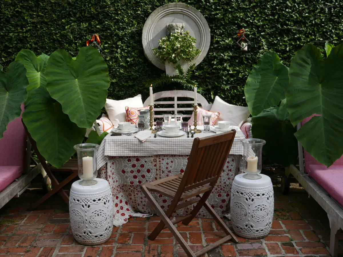 Set the scene with comfy pillows, greenery, and glowing candlelight for when the sun goes down. (Victoria de la Maza)