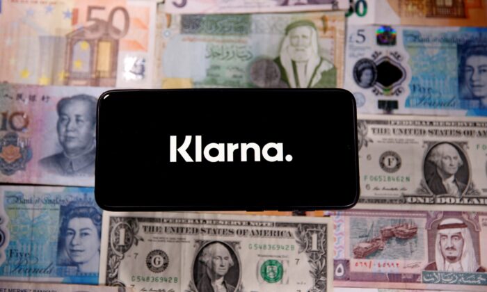 A smartphone displays a Klarna logo on top of banknotes is in this illustration taken on Jan. 6, 2020. (Dado Ruvic/Illustration/Reuters)
