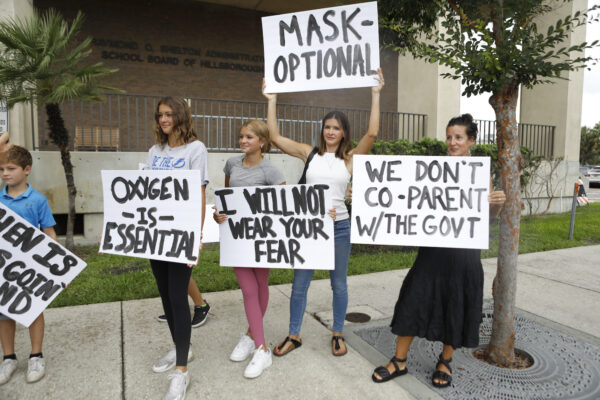 Families protest any potential mask mandates before the Hillsborough County Schools Board meeting held at the district office on July 27, 2021 in Tampa, Florida.