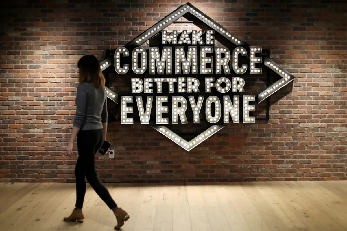 An employee walks past a sign at Shopify's headquarters in Ottawa, Ontario, Canada, on Oct. 22, 2018. (Chris Wattie/Reuters)