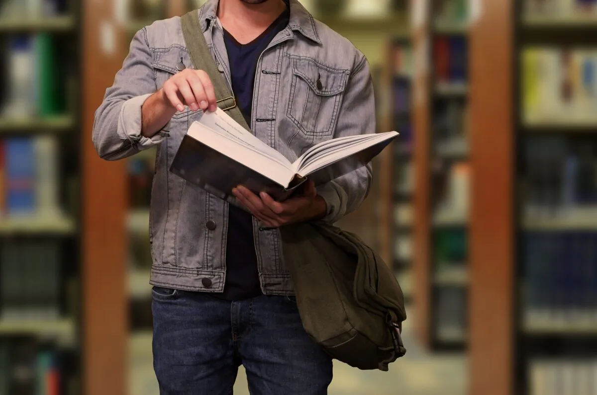 In this file photo, a college student reads a book in the library. (Gerd Altmann/Pixabay.com)