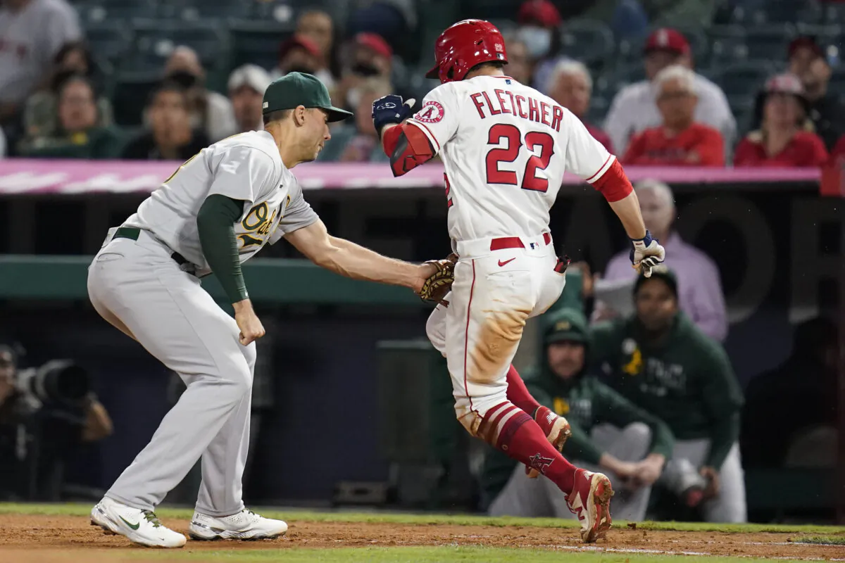 Los Angeles Angels' David Fletcher (22) is tagged out by Oakland Athletics first baseman Matt Olson during the seventh inning of a baseball game in Anaheim, Calif., on Sept. 17, 2021. (AP Photo/Ashley Landis)