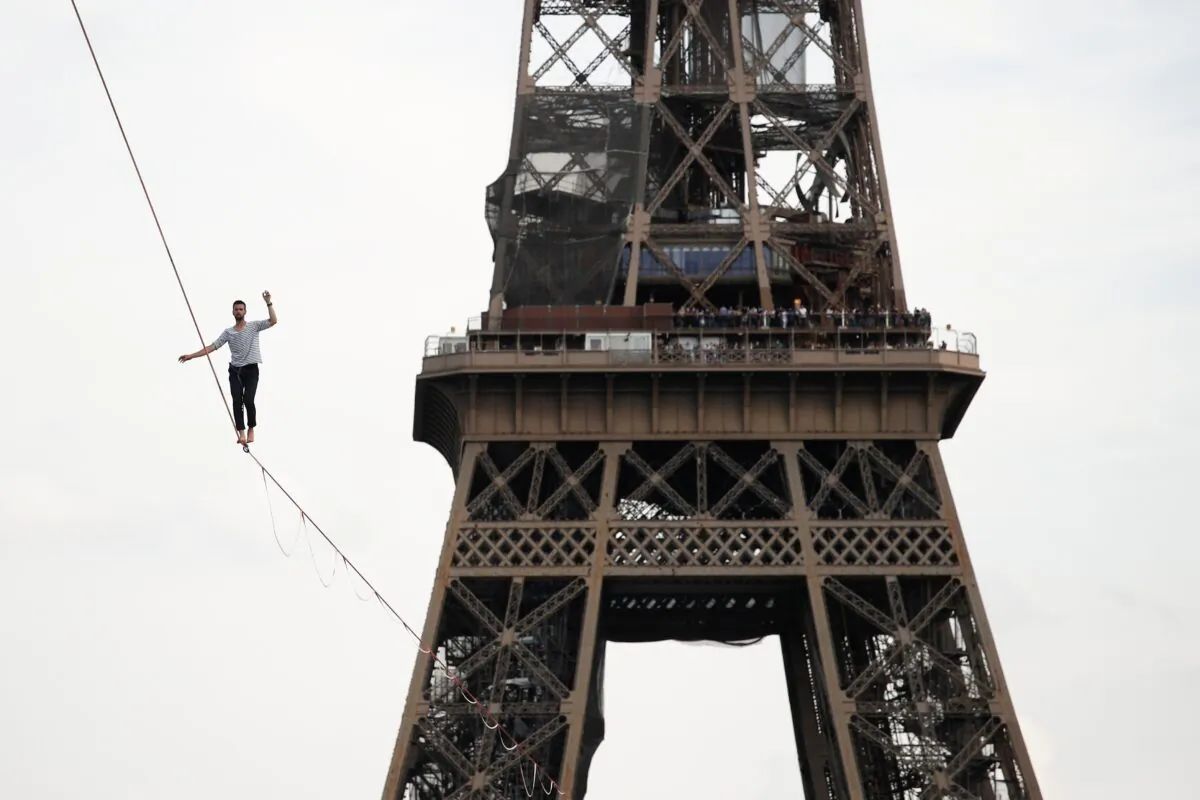 French acrobat Nathan Paulin walks on a slackline between the Eiffel Tower and the Theatre National de Chaillot as part of events around France for National Heritage Day in Paris, France, on Sept. 18, 2021. (Benoit Tessier/Reuters)