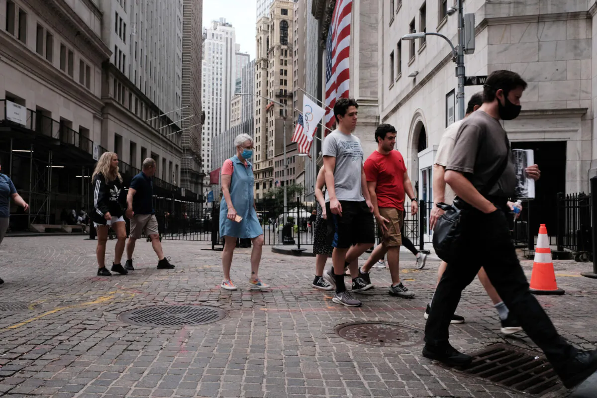 People walk by the New York Stock Exchange (NYSE) on August 10, 2021, in New York. (Spencer Platt/Getty Images)