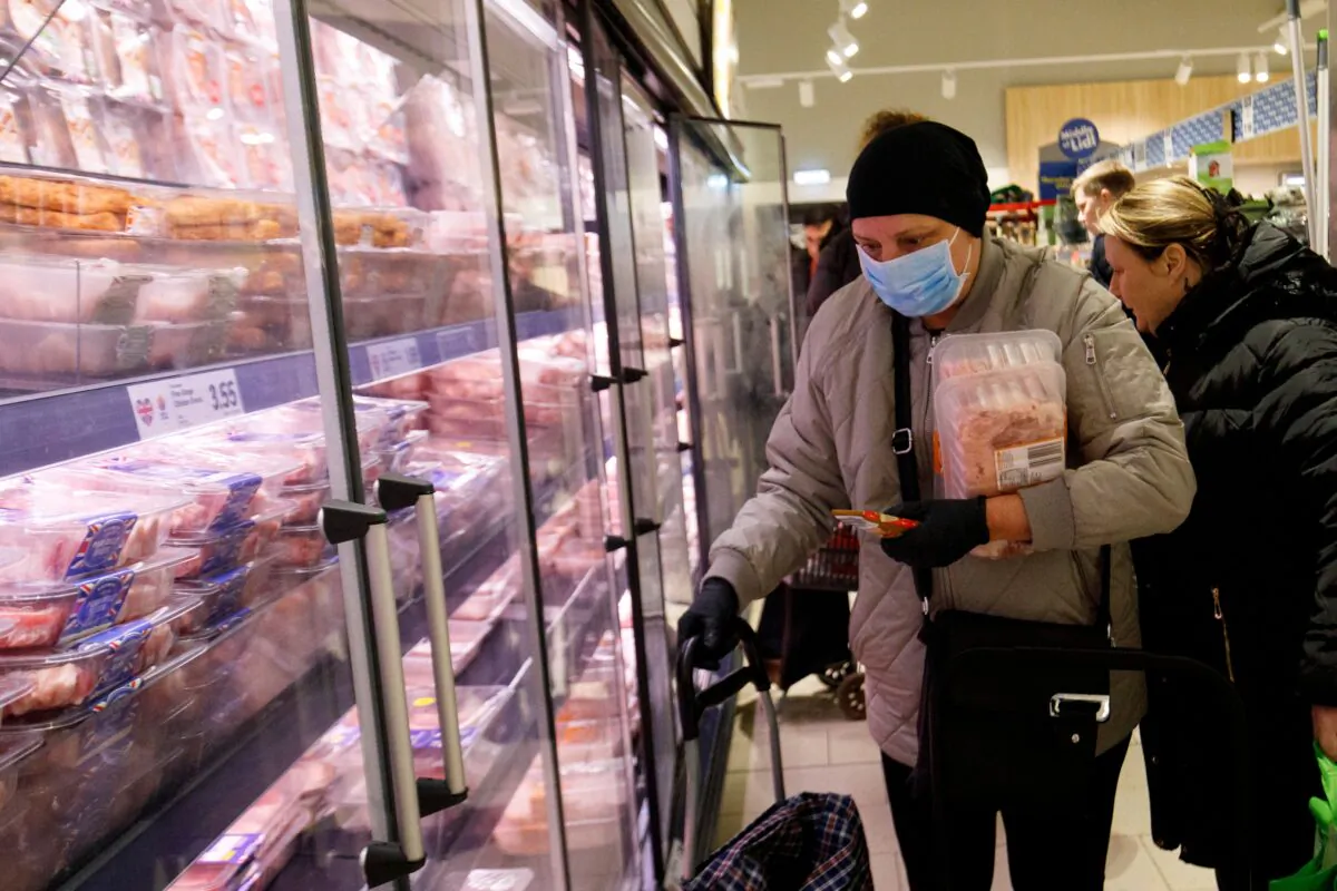 People shop in the meat aisle in a Lidl supermarket in Walthamstow, east London, on March 20, 2020. (Tolga Akmen/AFP via Getty Images)