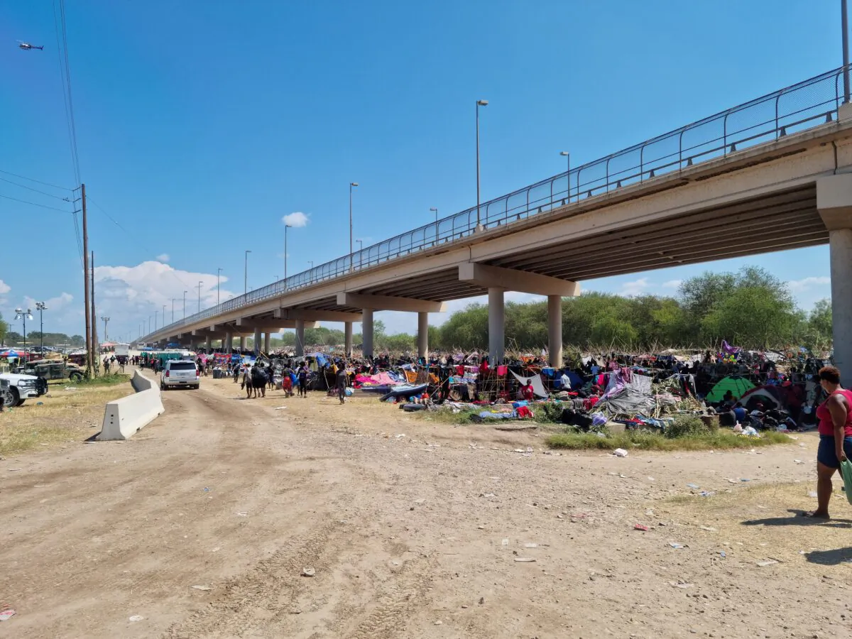 Illegal immigrants sheltering under the Del Rio International Bridge that connects with Ciudad Acuña in Mexico are seen in the border community of Del Rio, Texas, on Sept. 18, 2021. (Handout via Reuters)