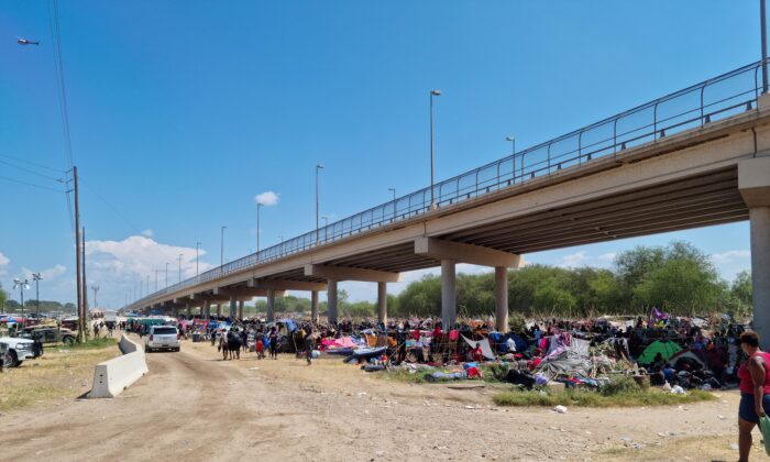 Illegal immigrants sheltering under the Del Rio International Bridge that connects with Ciudad Acuna in Mexico are seen in the border community of Del Rio, Texas, on Sept. 18, 2021. (Handout via Reuters)