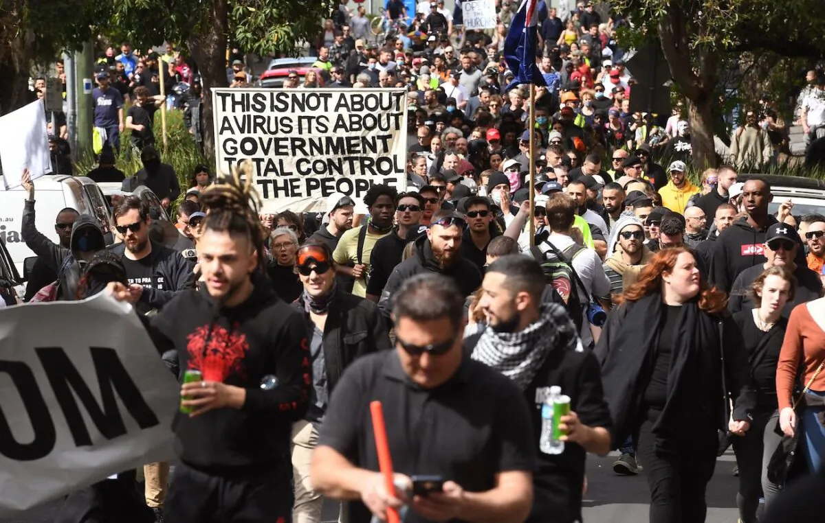 Protesters march through the streets during a rally against government COVID-19 restrictions in Melbourne on Sept. 18, 2021. (William West/AFP via Getty Images)