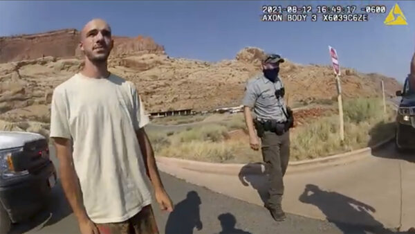 In this screenshot from a police camera video, Brian Laundrie talks to a police officer after police pulled over the van he was traveling in with his girlfriend, Gabrielle “Gabby” Petito, near the entrance to Arches National Park, Utah, on Aug. 12, 2021. (The Moab Police Department via AP)