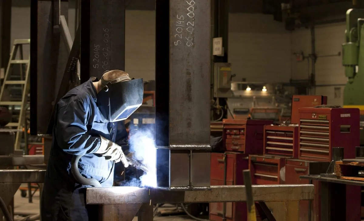 A welder works in a factory in Quebec City, in a file photo. (The Canadian Press/Jacques Boissinot)