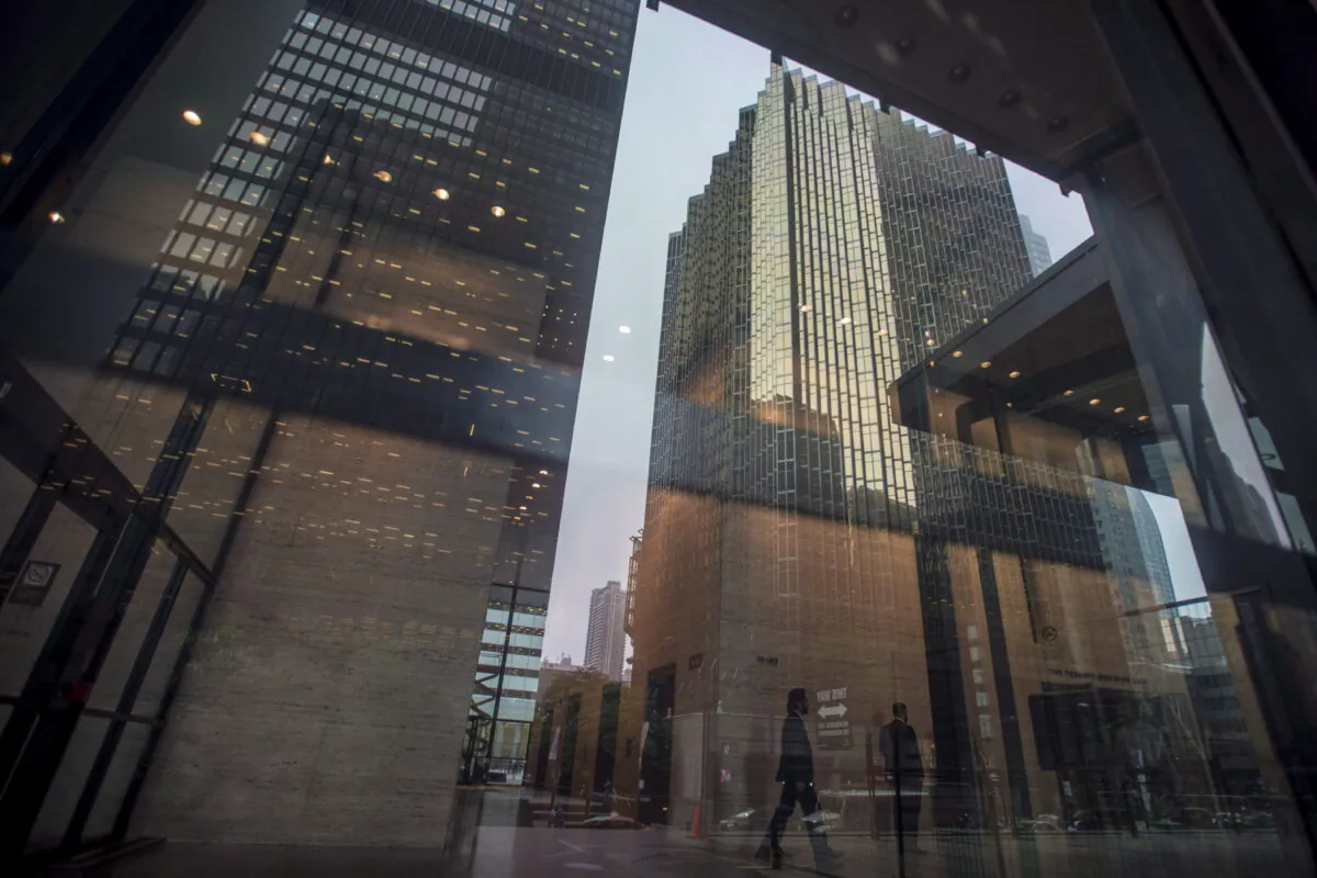 The financial district is reflected on a window in the Toronto Dominion Centre in downtown Toronto on June 27, 2018. (The Canadian Press/Tijana Martin)