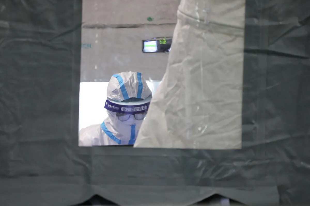 A laboratory technician wearing personal protective equipment shows at a temporary COVID-19 testing facility in Xiamen, Fujian Province, China, another hotspot of the latest outbreak on Sept. 16, 2021. (STR/AFP via Getty Images)