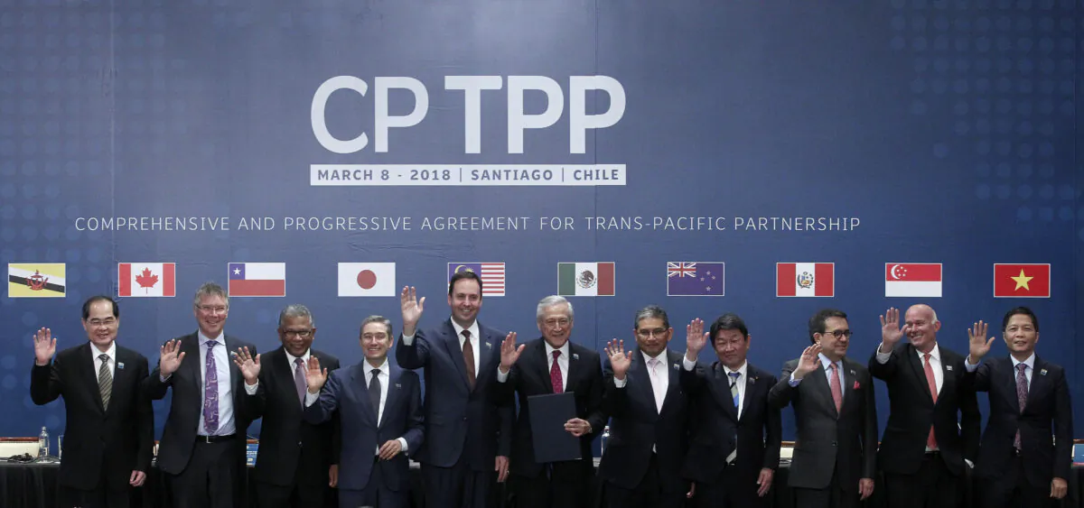 (L-R) Trade or foreign ministers of Singapore, New Zealand, Malaysia, Canada, Australia, Chile, Brunei, Japan, Mexico, Peru, and Vietnam pose for an official picture after signing the rebranded 11-nation Pacific trade pact Comprehensive and Progressive Agreement for Trans-Pacific Partnership (CPTPP) in Santiago, Chile, on March 8, 2018. (Claudio Reyes/AFP via Getty Images)
