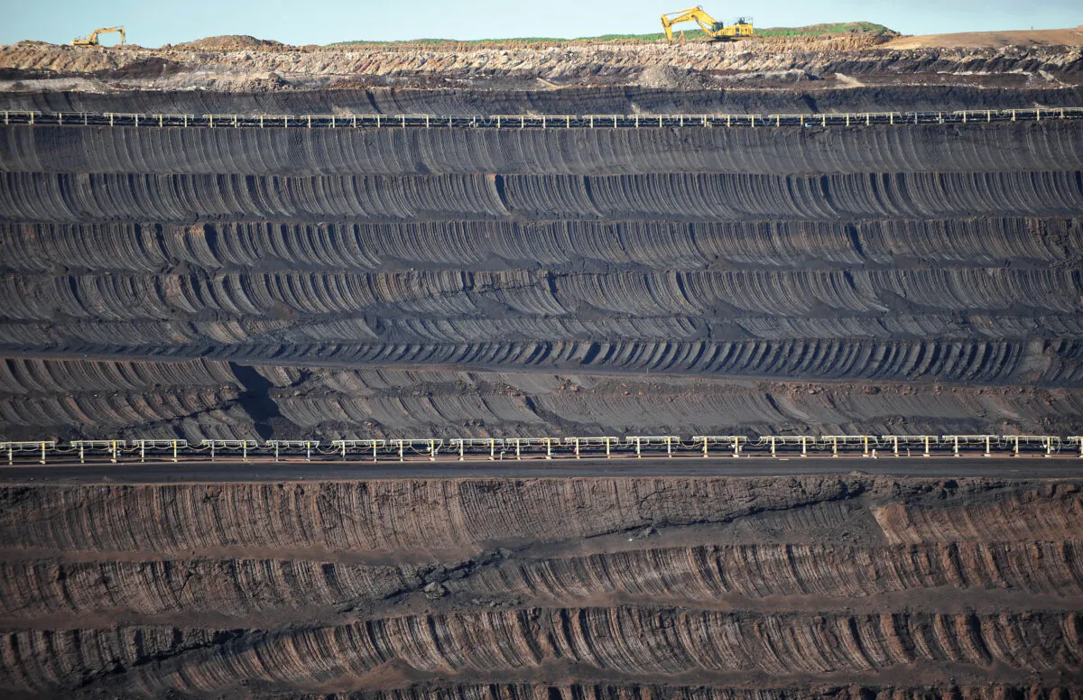 Large excavators are dwarfed by the face of the Loy Yang Open Cut coal mine in the Latrobe Valley, Victoria, on Aug. 13, 2009. (PAUL CROCK/AFP via Getty Images)