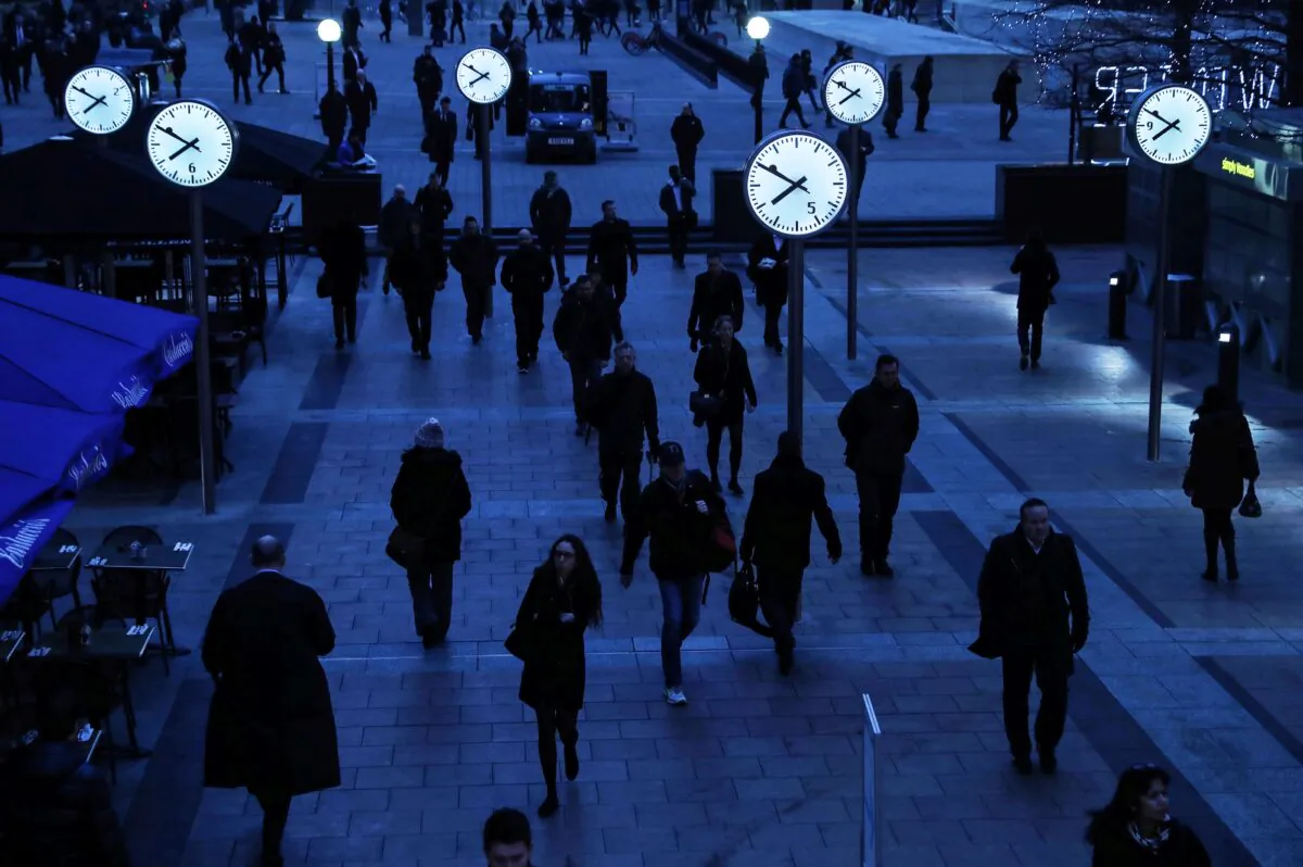 Workers walk to work during the morning rush hour in the financial district of Canary Wharf in London on Jan. 26, 2017. (Eddie Keogh/Reuters)