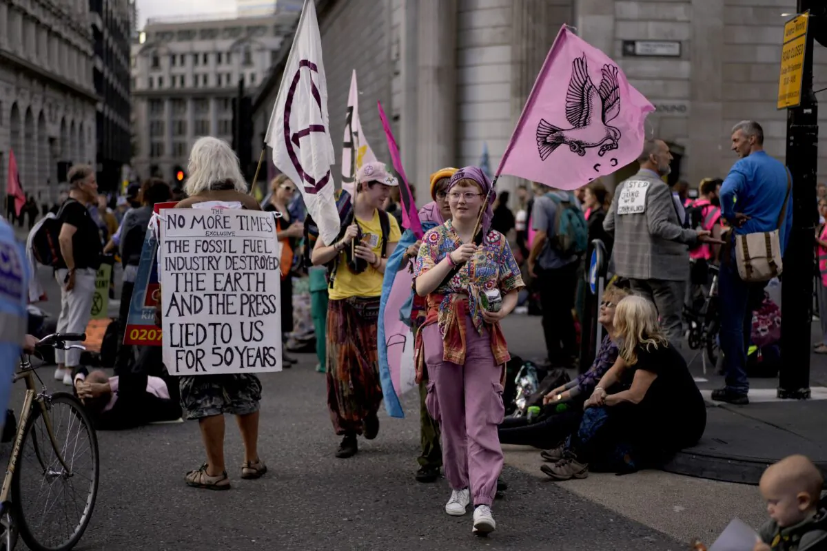 Extinction Rebellion climate change activists take part in a protest outside the Bank of England in London on Sept. 2, 2021. (AP Photo/Matt Dunham)