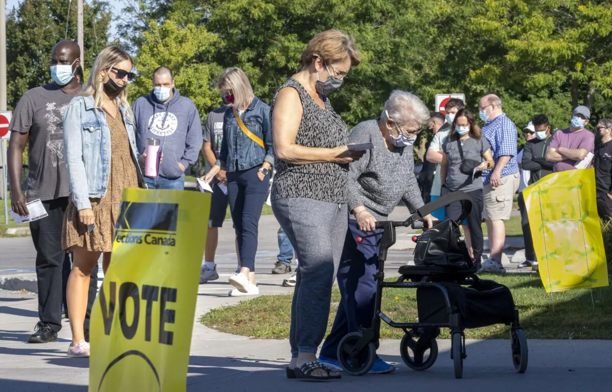 Voters line up to vote at a polling station in Bowmanville, Ont., on Sept. 20, 2021. (The Canadian Press/Frank Gunn)