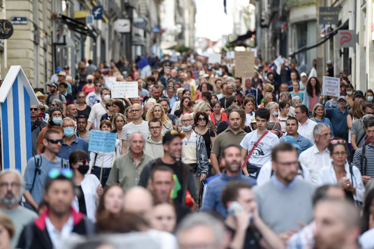 Demonstrators hold placards and chant slogans as they march during a rally in Nantes, western France, on Sept. 18, 2021. (Sebastien Salom-gomis/AFP via Getty Images)