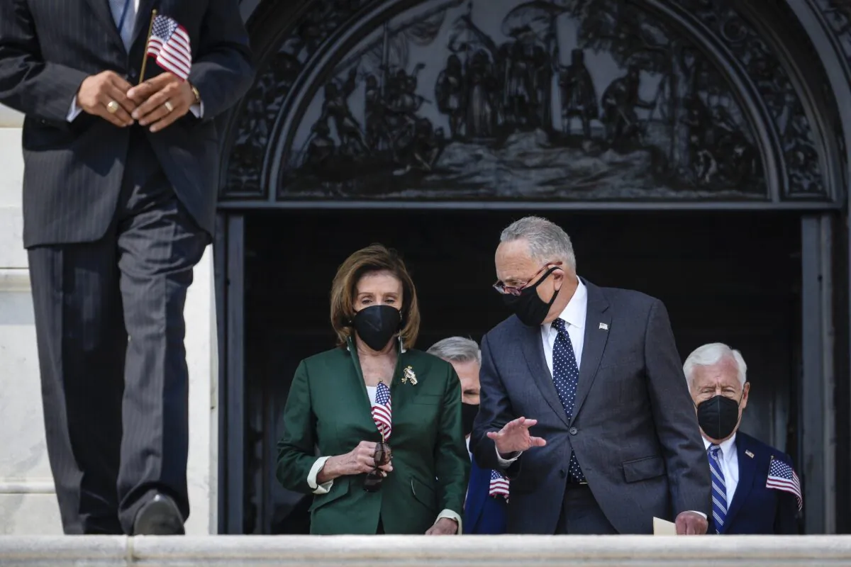 (L-R) Speaker of the House Nancy Pelosi (D-Calif.) and Senate Majority Leader Chuck Schumer (D-N.Y.) talk with each other as they walk down the steps of the U.S. Capitol  in Washington, on Sept. 13, 2021.  (Drew Angerer/Getty Images)