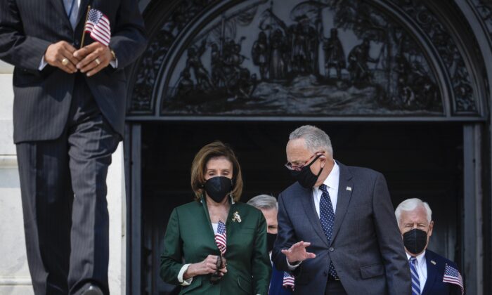 (L-R) Speaker of the House Nancy Pelosi (D-Calif.) and Senate Majority Leader Chuck Schumer (D-N.Y.) talk with each other as they walk down the steps of the U.S. Capitol on Sept. 13, 2021.  (Drew Angerer/Getty Images)