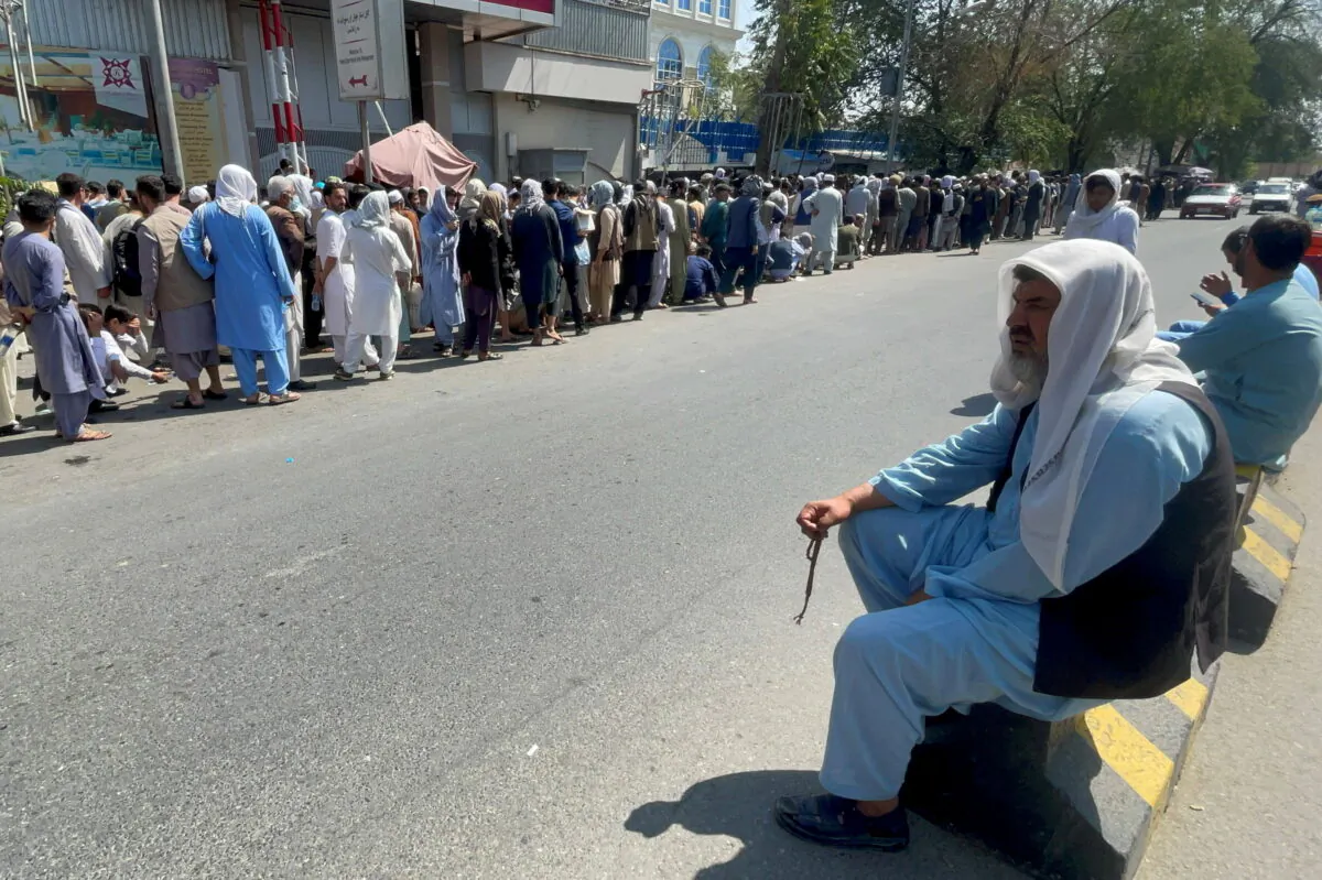 Afghans line up outside a bank to take out their money after Taliban takeover in Kabul, Afghanistan, on Sept.1, 2021. (Stringer/Reuters)