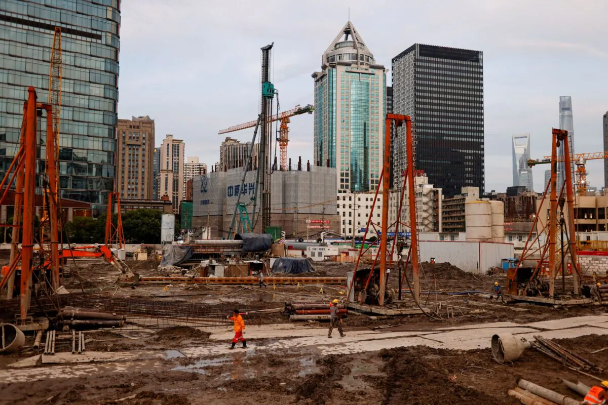Workers labor at a construction site in Shanghai, China, on July 12, 2021. (Aly Song/Reuters)