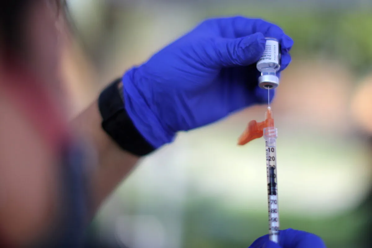A nurse prepares a Pfizer BioNTech COVID-19 vaccination as part of a vaccine drive by the Fernandeno Tataviam Band of Mission Indians in Arleta, Los Angeles, on Aug. 23, 2021. (Lucy Nicholson/Reuters)
