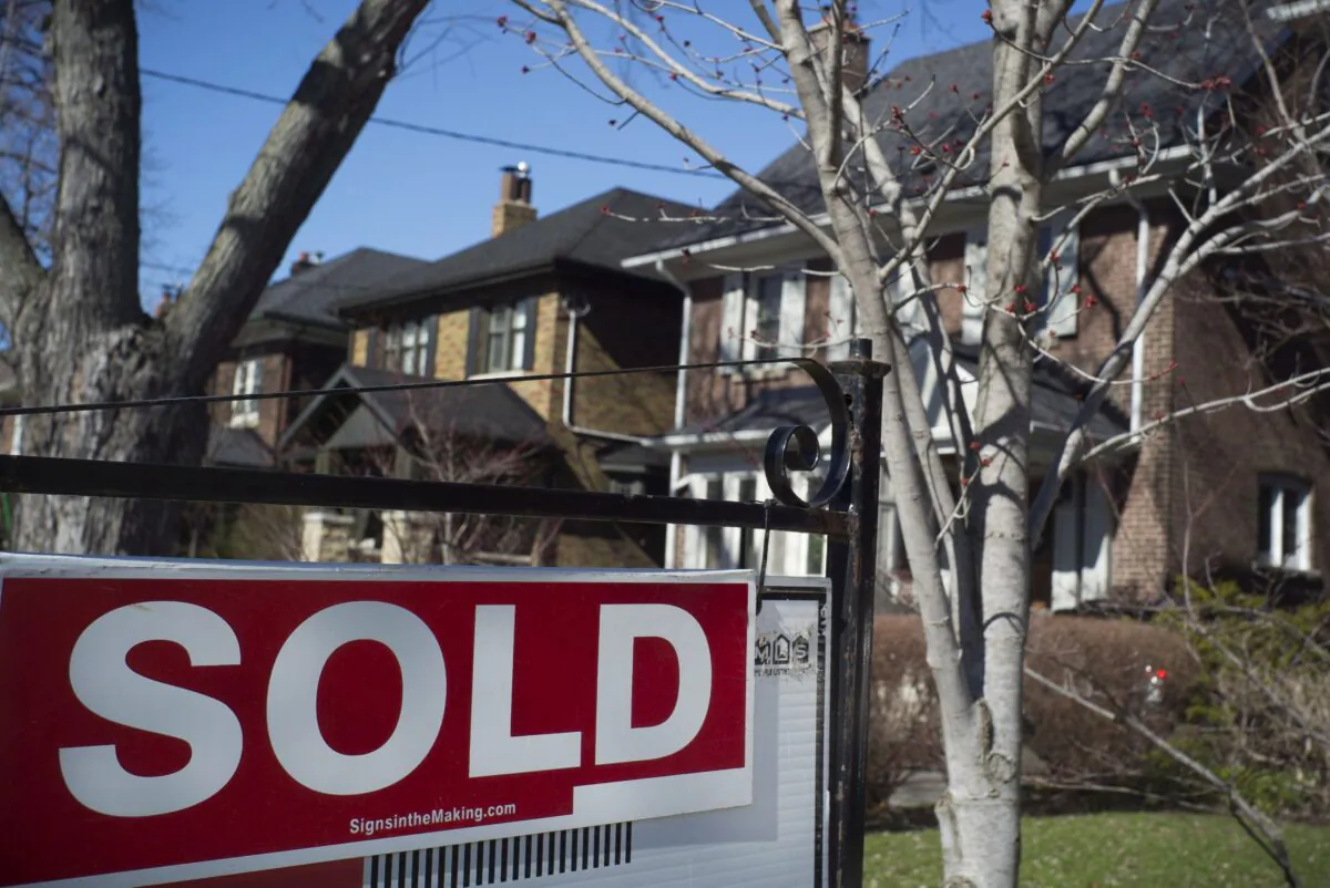 A sold sign in front of a west-end Toronto home in a file photo. (The Canadian Press/Graeme Roy)