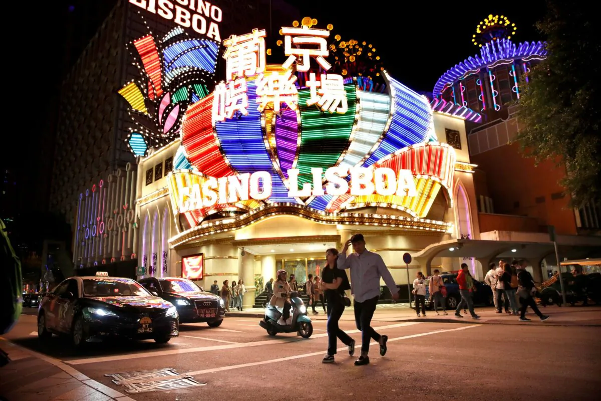 People walk in front of Casino Lisboa in Macau on Dec. 21, 2019. (Jason Lee/Reuters)
