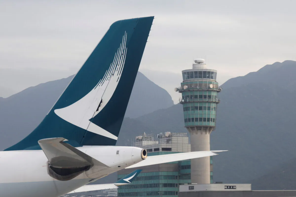 A Cathay Pacific jet is seen in front of air traffic control tower at the Hong Kong International Airport on Oct. 24 2020. (Tyrone Siu/Reuters)