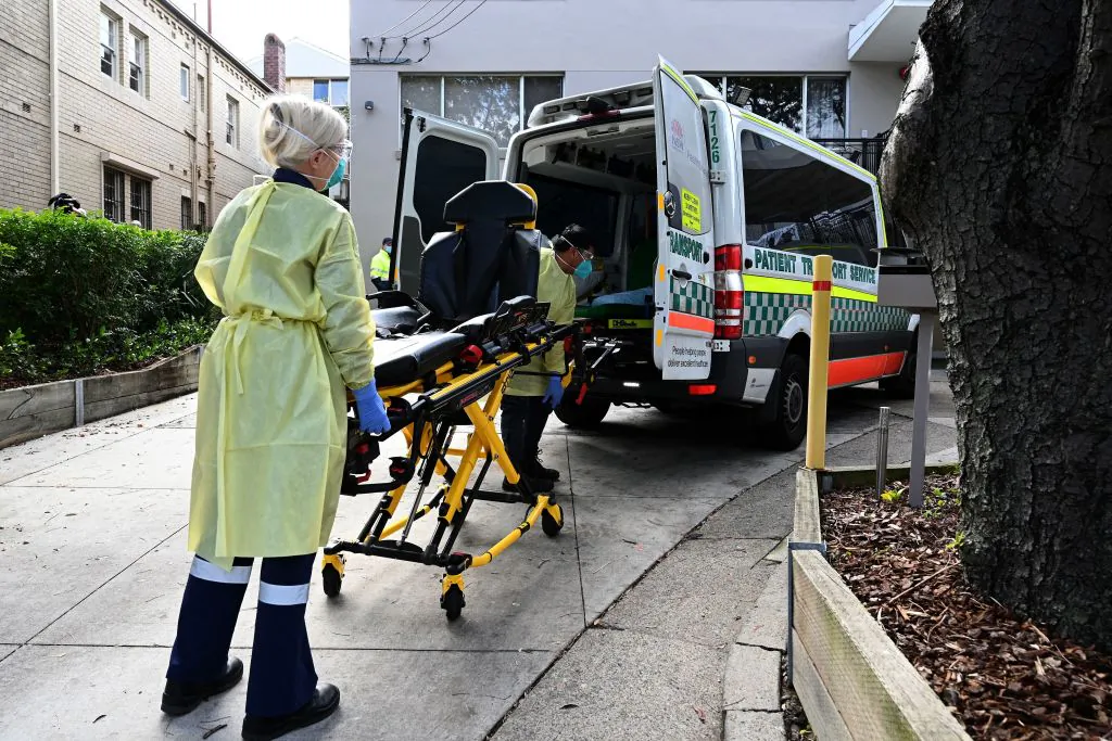 Health workers take out stretchers from an ambulance at the Hardi Aged Care Nursing Home Facility in Summers Hill suburb of Sydney, Australia on Aug. 2, 2021, (Saeed Khan/AFP via Getty Images)