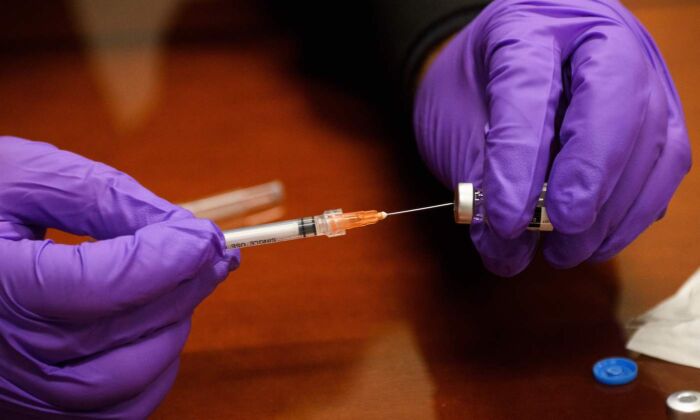 A COVID-19 vaccine. (Patrick T. Fallon/AFP via Getty Images)