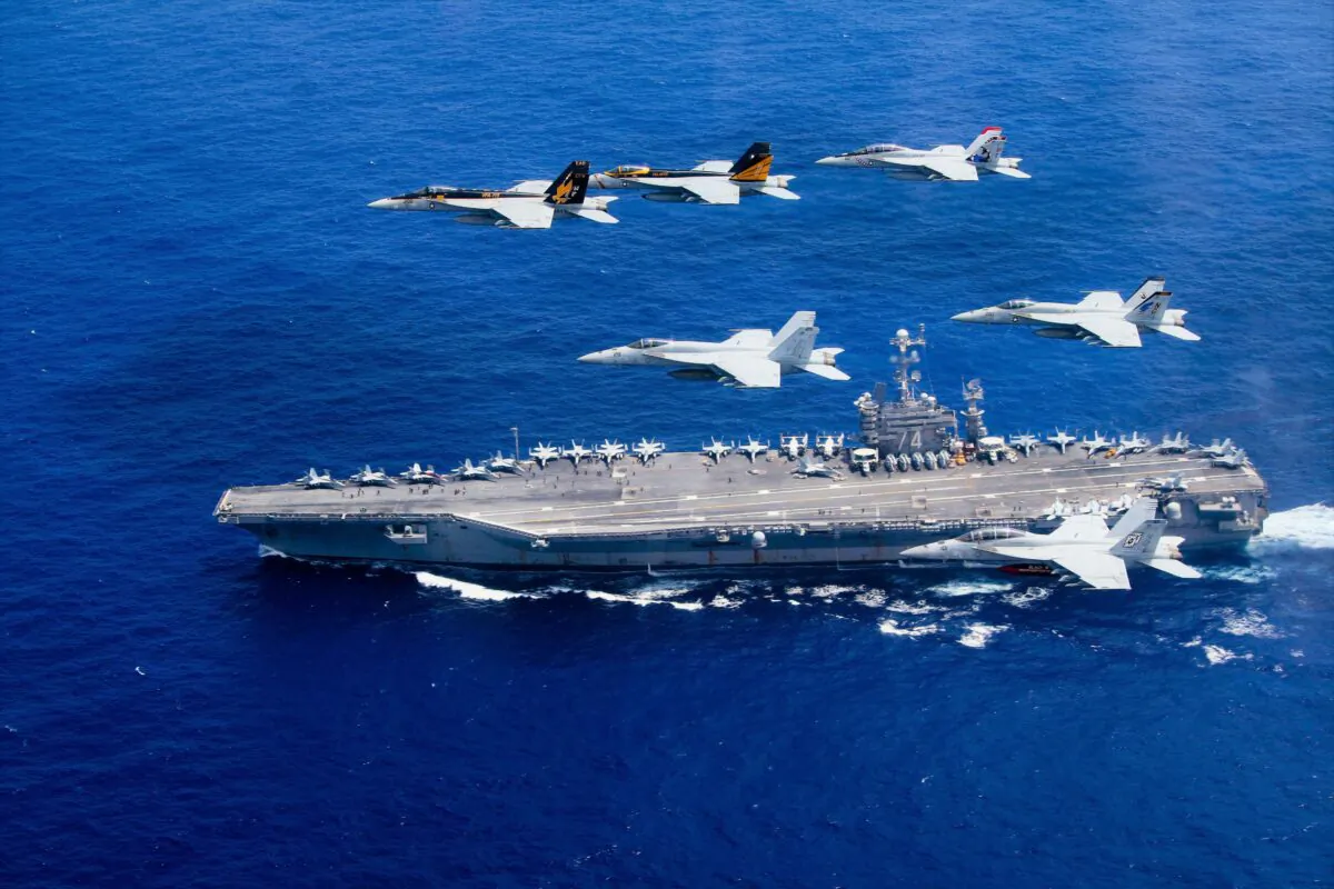 Aircraft pass in formation above the Nimitz-class aircraft carrier USS John C. Stennis in the Philippine Sea on June 18, 2021. (Lt. Steve Smith/U.S. Navy via Getty Images)