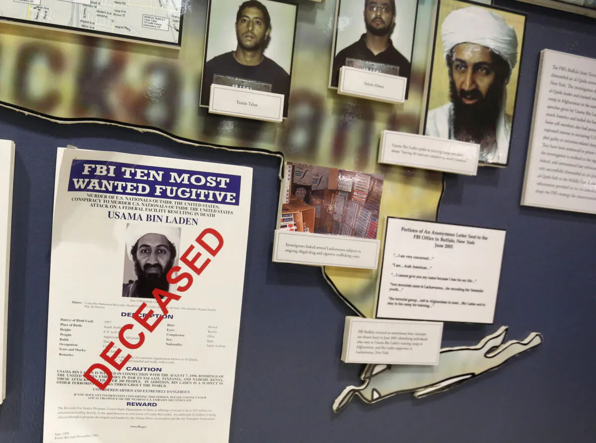 The FBI's Ten Most Wanted Fugitive poster for Osama Bin Laden with the word "DECEASED" printed in red across it, hangs on the wall at the FBI Headquarters in Washington, on Nov. 26, 2013.  (Larry Downing/Reuters)