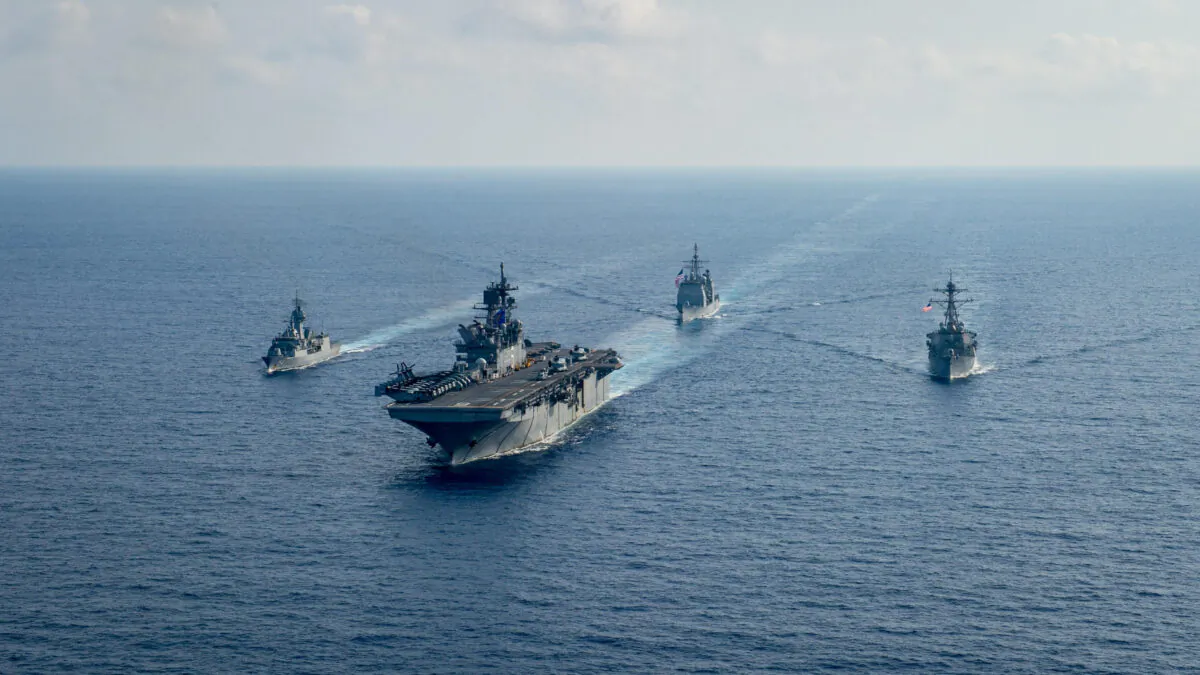 Royal Australian Navy guided-missile frigate HMAS Parramatta (FFH 154) (L) sails with U.S. Navy Amphibious assault ship USS America (LHA 6), Ticonderoga-class guided-missile cruiser USS Bunker Hill (CG 52) and Arleigh-Burke class guided missile destroyer USS Barry (DDG 52) in the South China Sea, on April 18, 2020. (Petty Officer 3rd Class Nicholas Huynh/U.S. Navy/Handout via Reuters)