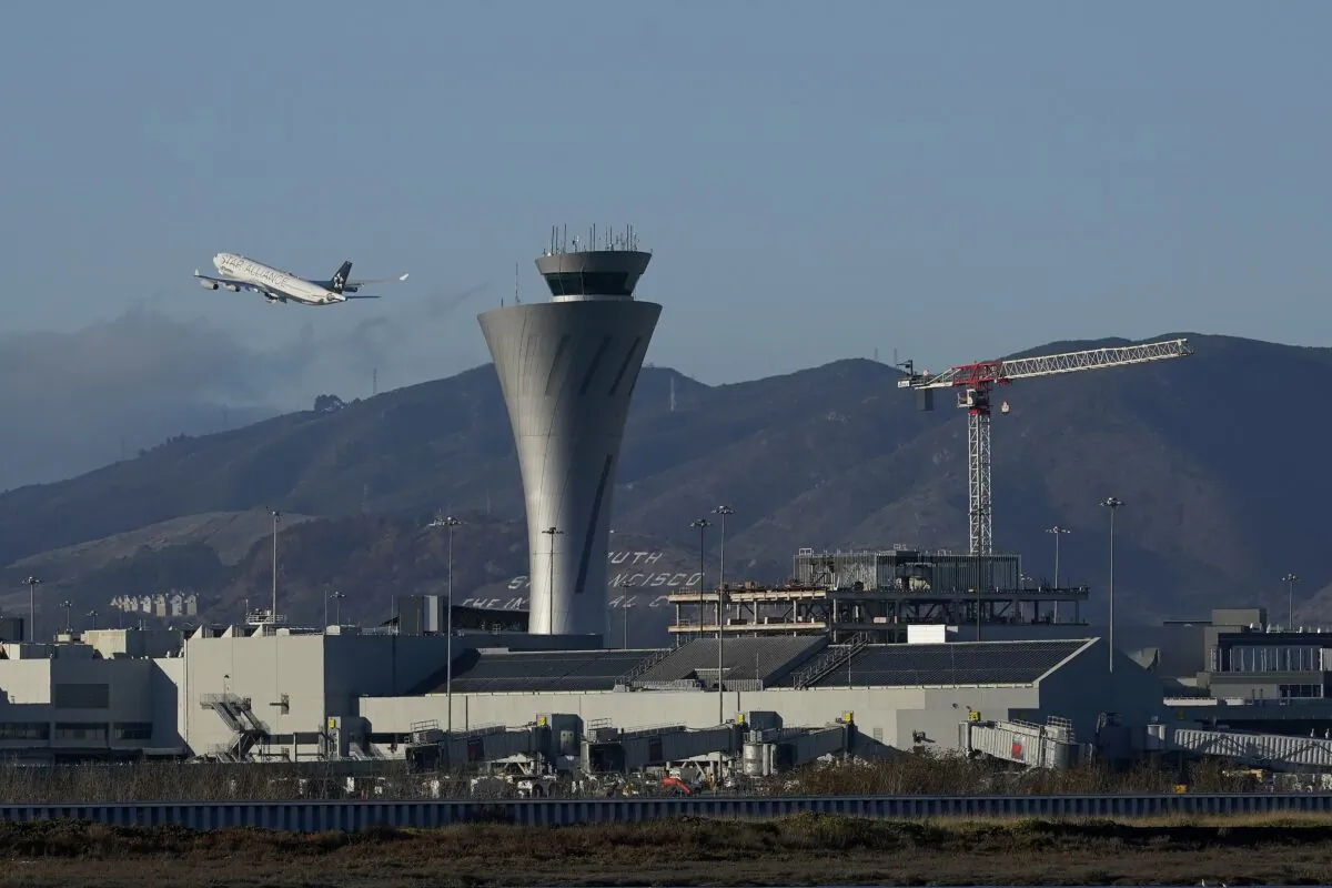 A plane takes off behind the air traffic control tower at San Francisco International Airport in San Francisco, on Nov. 24, 2020. (Jeff Chiu/AP Photo)