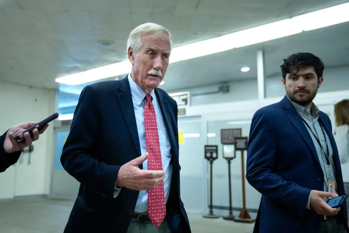 Sen. Angus King (I-Maine) talks with reporters as he walks through the Senate subway on his way to a vote at the Capitol in Washington on June 21, 2021. (Drew Angerer/Getty Images)