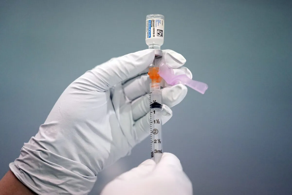 A member of the Philadelphia Fire Department prepares a dose of the Johnson & Johnson COVID-19 vaccine at a vaccination site setup in Philadelphia on March 26, 2021. (Matt Rourke/AP Photo)
