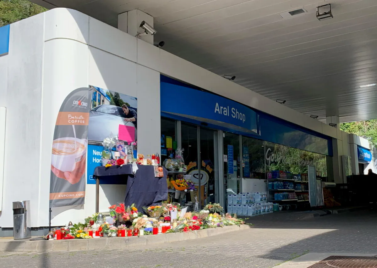 Flowers are placed in front of a gas station in Idar-Oberstein, Germany, on Sept. 21, 2021. (Annkathrin Weiss/Reuters)