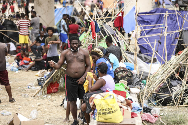 Thousands of illegal immigrants, mostly Haitians, live in a primitive, makeshift camp under the international bridge that spans the Rio Grande between the U.S. and Mexico while waiting to be detained and processed by Border Patrol, in Del Rio, Texas, on Sept. 21, 2021. (Charlotte Cuthbertson/The Epoch Times)