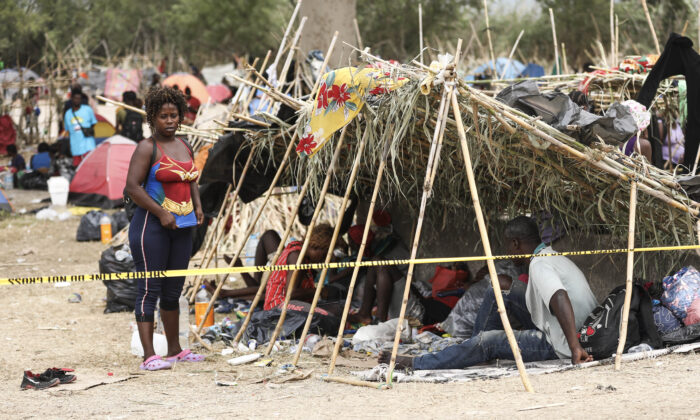 Thousands of illegal immigrants, mostly Haitians, live in a primitive, makeshift camp under the international bridge that spans the Rio Grande between the United States and Mexico while waiting to be detained and processed by Border Patrol, in Del Rio, Texas, on Sept. 21, 2021. (Charlotte Cuthbertson/The Epoch Times)