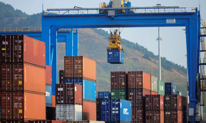 A crane loading and lifting containers at an automated cargo wharf in Qingdao in China's eastern Shandong Province, on Oct. 24, 2018. (STR/AFP via Getty Images)