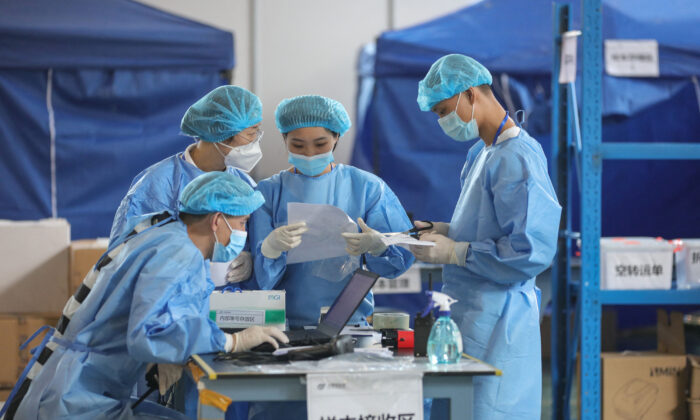 Laboratory technicians wearing personal protective equipment while working in China. (STR/AFP via Getty Images)