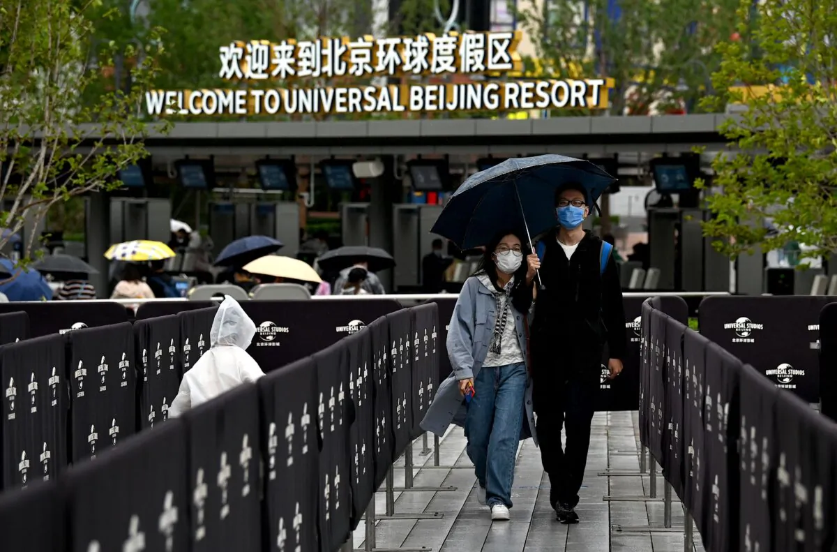 People queue to enter the Universal Studios Beijing theme park during its opening in Beijing, China on Sept. 20, 2021. (NOEL CELIS/AFP via Getty Images)