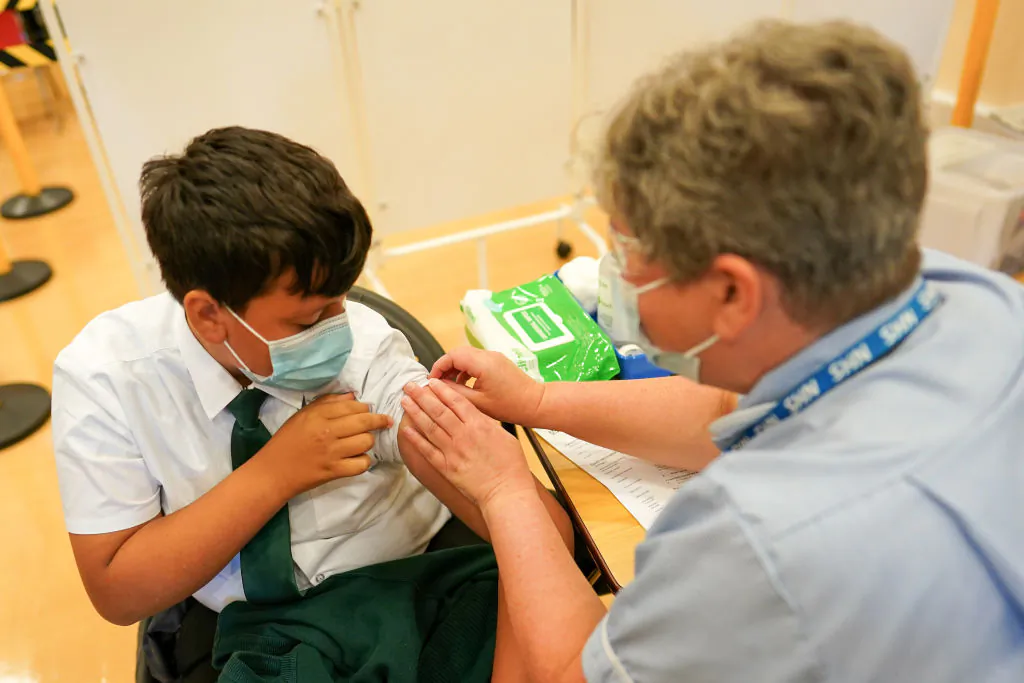 13-year-old boy from Newcastle receives the Pfizer-BioNTech COVID-19 vaccine at the Excelsior Academy in Newcastle upon Tyne, England, on Sept. 22, 2021. (Ian Forsyth/Getty Images)