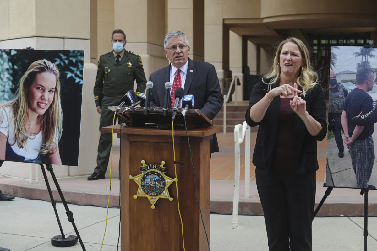 At left is a photo of student Kristin Smart. Cal Poly President Jeffrey Armstrong, center, speaks during a news conference in San Luis Obispo, Calif., on April 13, 2021. (David Middlecamp/The Tribune (of San Luis Obispo) via AP, File)