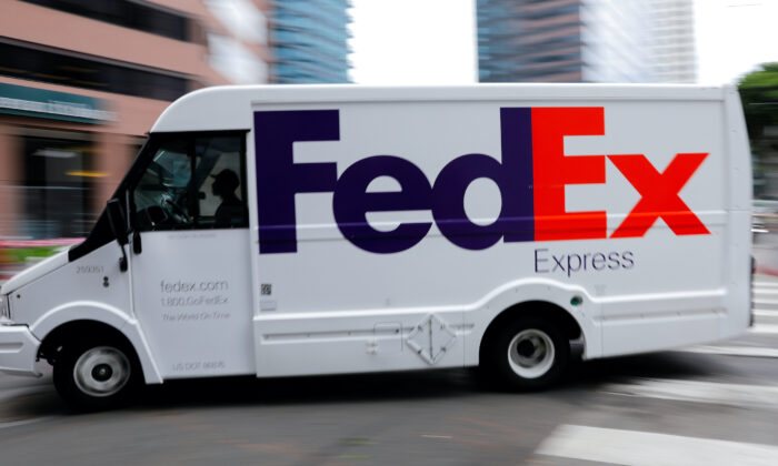 A FedEx truck is driven through downtown in Los Angeles, on July 22, 2019. (Mike Blake/Reuters)