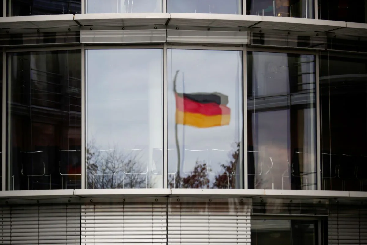 A German flag is reflected in the window of the Paul Loebe building in Berlin, Germany on Nov. 19, 2020. (Hannibal Hanschke/Reuters)