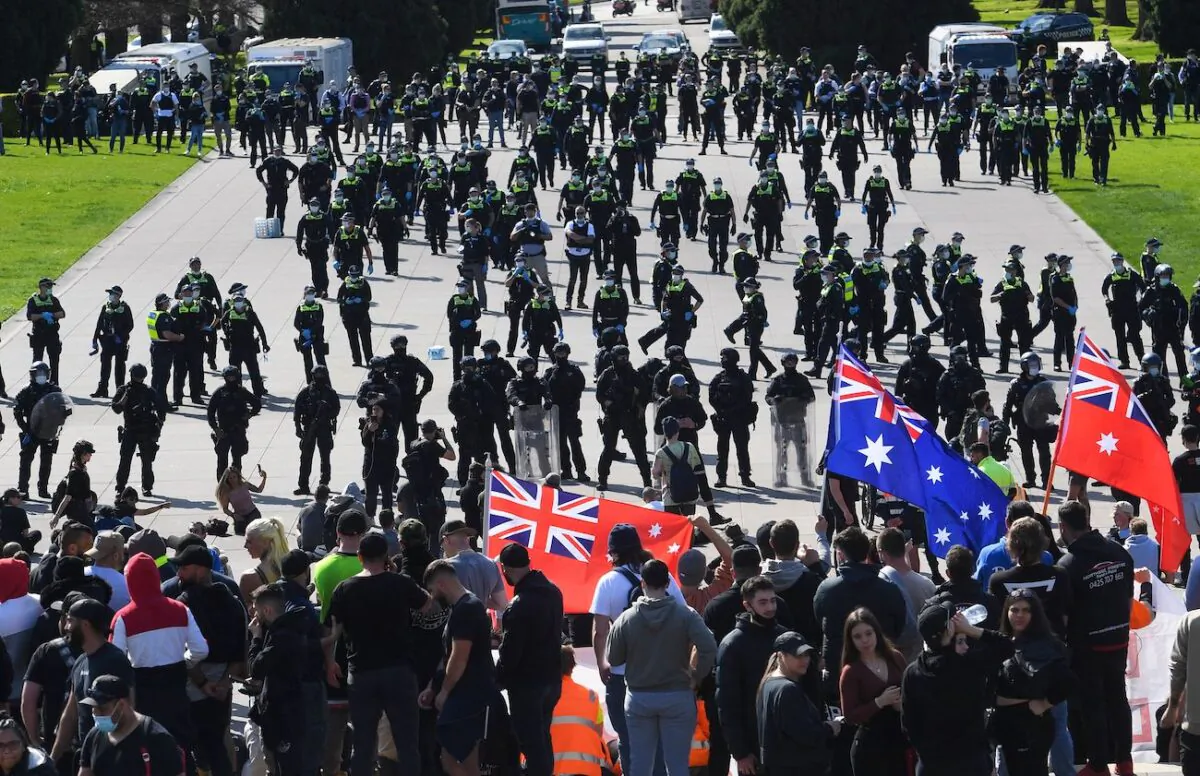 Police arrest construction workers and demonstrators with tear gas on the steps of the Shrine of Remembrance during a protest against Covid-19 regulations in Melbourne, Australia, on Sept. 22, 2021. (William West/AFP via Getty Images)